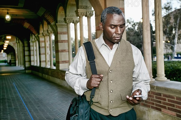 African American professor smiling on campus