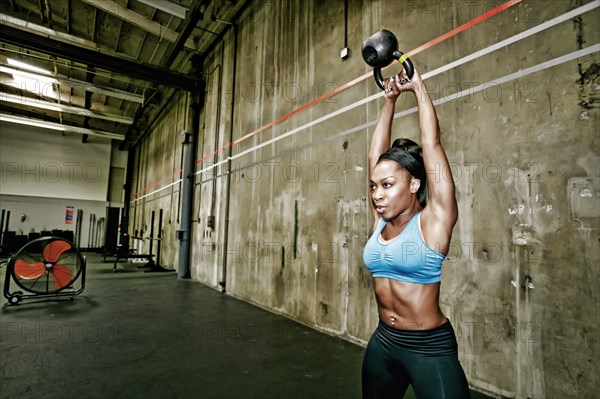 Mixed race woman exercising in gym