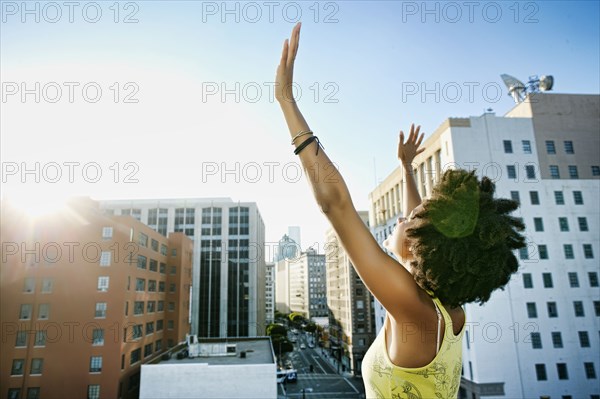 Mixed race woman on urban rooftop