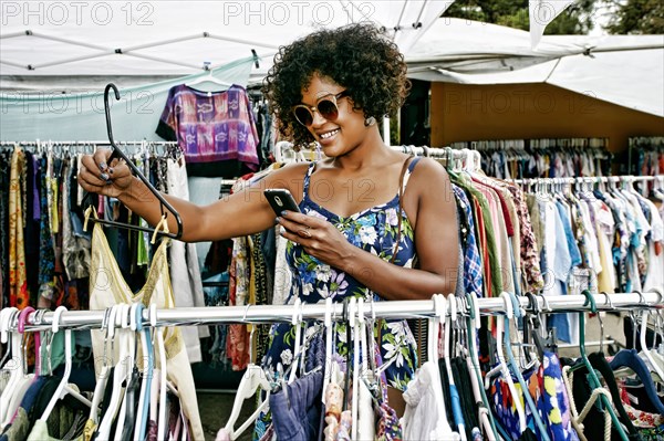 Mixed race woman shopping at flea market