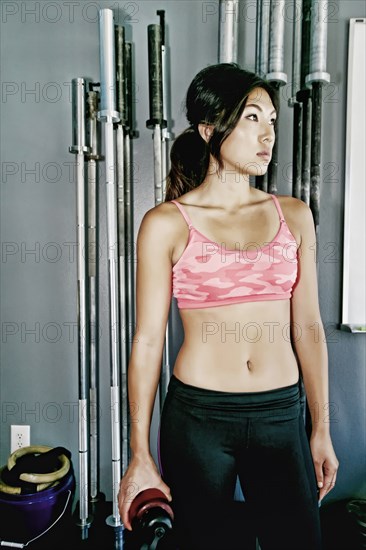 Asian woman working out in gym