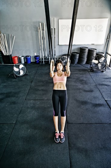 Asian woman working out in gym