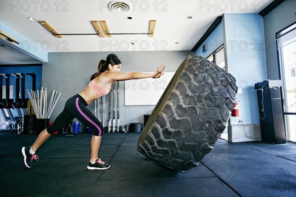 Asian woman working out in gym