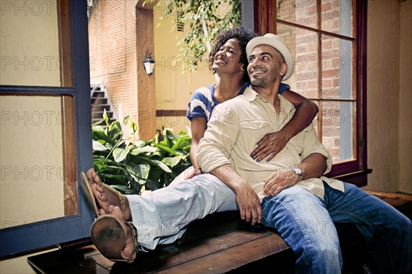 Couple relaxing together in windowsill