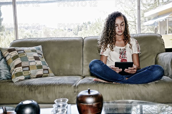 Mixed race girl using digital tablet