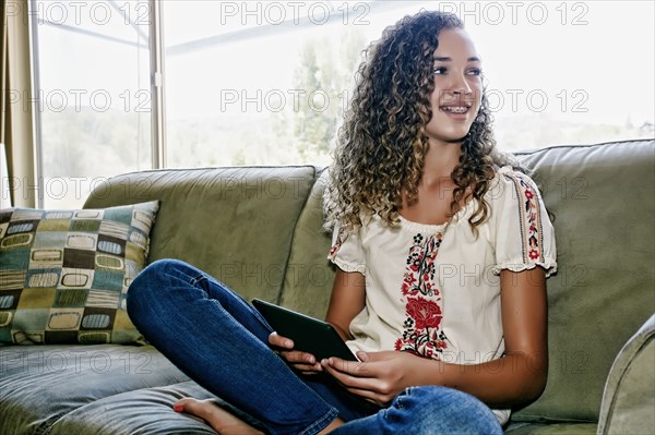 Mixed race girl using digital tablet