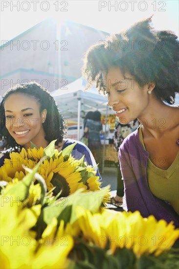 Women shopping together at flower stand