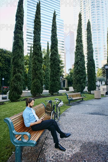 Caucasian businessman relaxing in urban park
