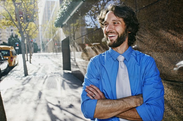 Caucasian businessman smiling on city street