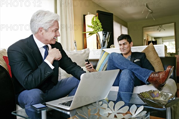 Businessmen talking in living room