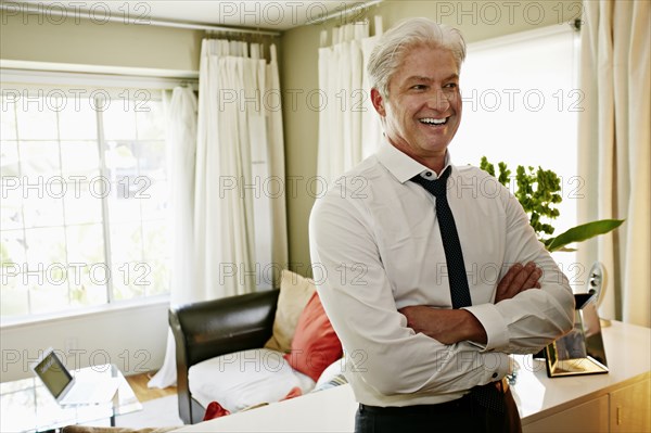 Businessman smiling in living room