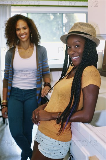 Women smiling together in kitchen