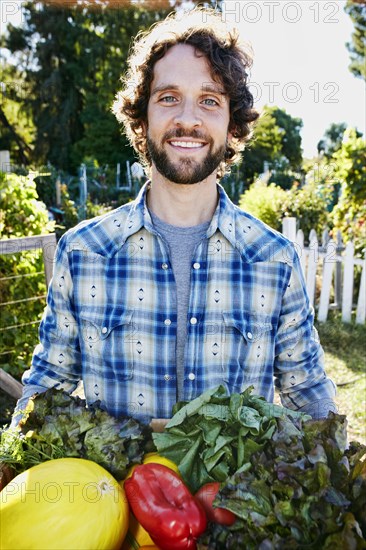 Caucasian man harvesting vegetables in garden