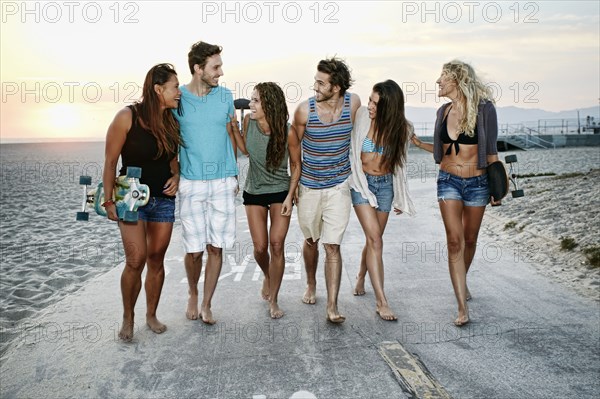 Friends walking together on beach