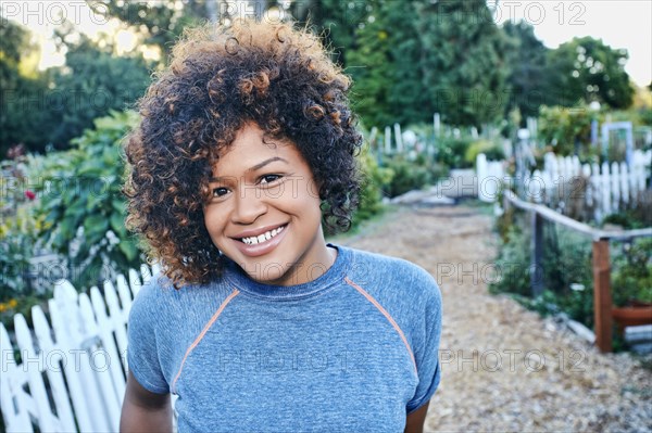 Mixed race woman smiling in garden