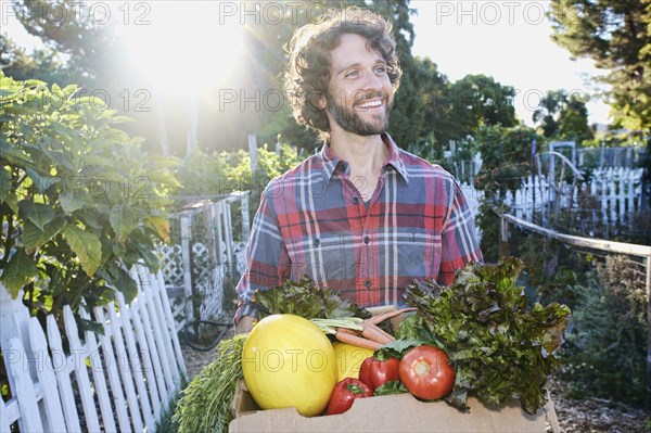 Caucasian man harvesting vegetables in garden