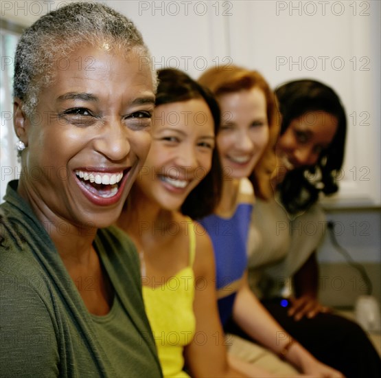 Women laughing together in kitchen
