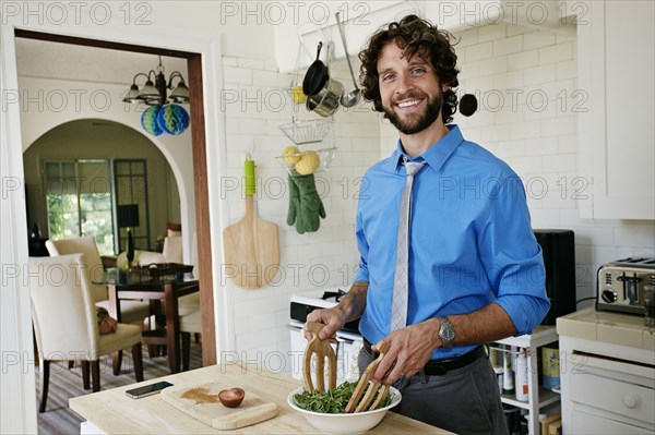 Caucasian businessman cooking in kitchen