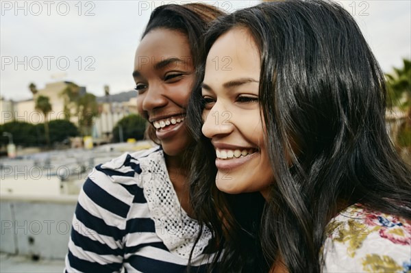 Women smiling on urban rooftop