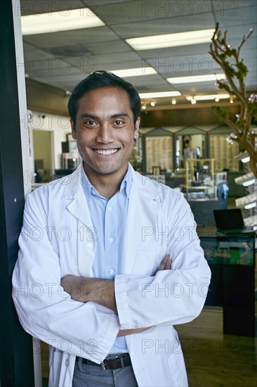 Filipino optometrist smiling in office