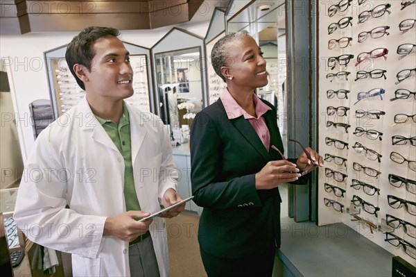 Woman trying on glasses at optometrist