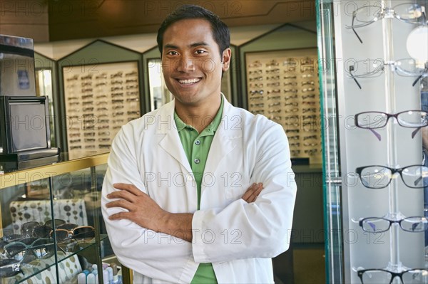 Filipino optometrist smiling in office