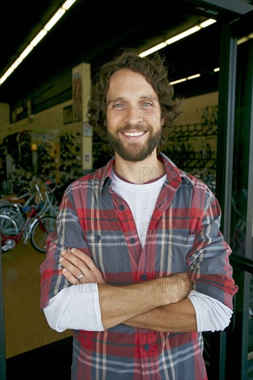 Caucasian man smiling in bicycle shop