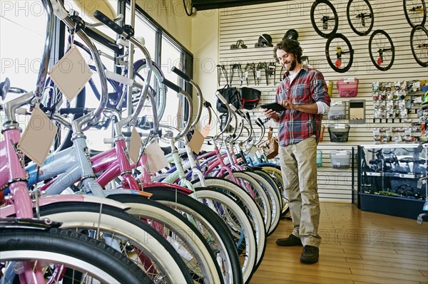 Caucasian man working in bicycle shop