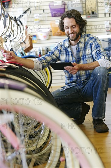 Caucasian man working in bicycle shop