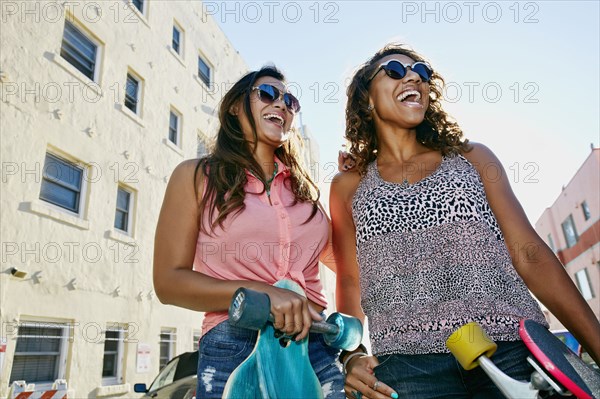Women laughing on city street