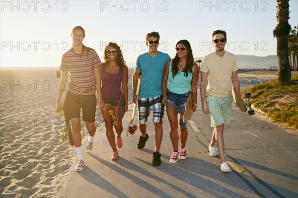 Friends walking together on beach