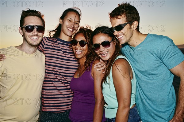 Friends smiling together on beach