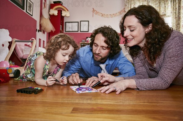 Caucasian family drawing in bedroom