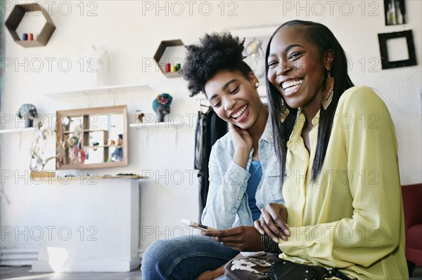 Women using cell phone in store