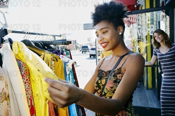 Mixed race woman shopping on city street