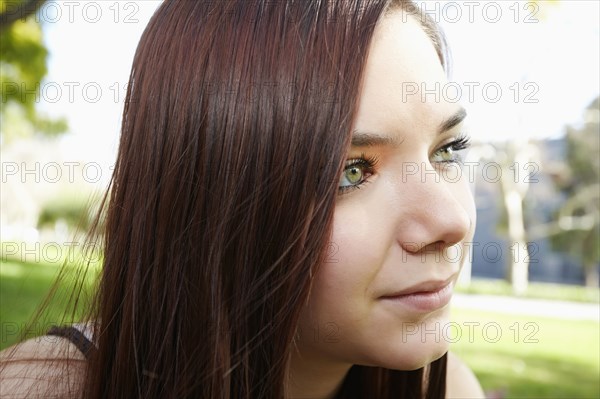 Caucasian girl sitting outdoors