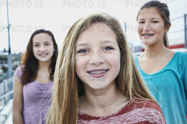 Teenage girls smiling on bleachers