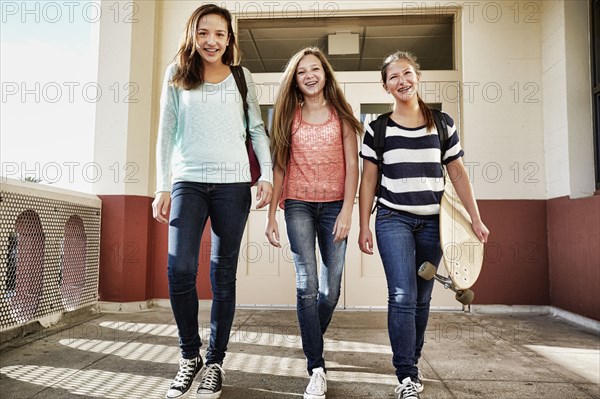 Teenage girls walking on school campus