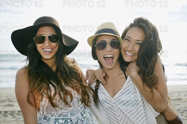 Women smiling together on beach