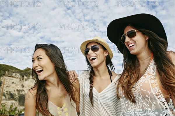 Women smiling together on beach