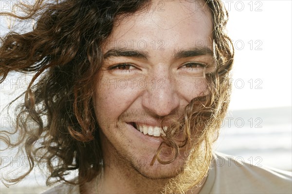 Caucasian man smiling on beach