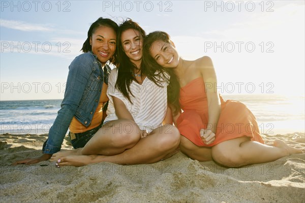 Women smiling together on beach