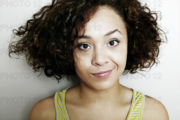 Mixed race woman smirking