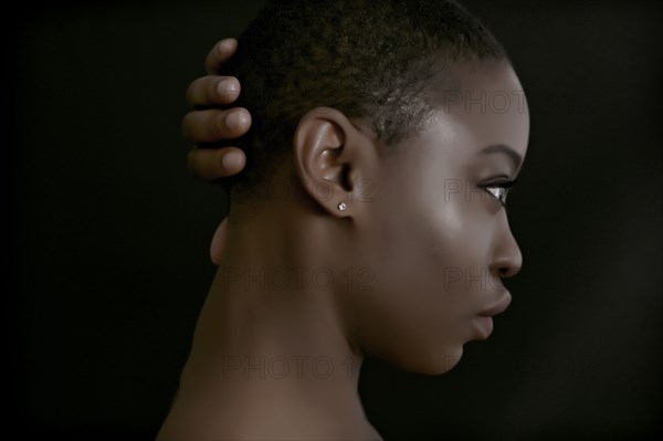 Black woman with hand behind head