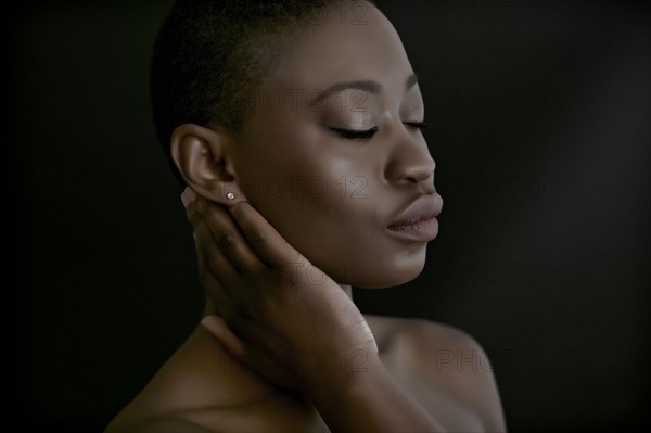 Black woman with hand on neck
