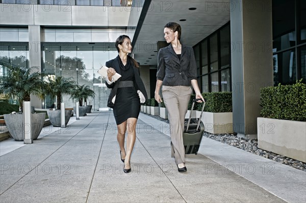 Businesswomen walking together outdoors