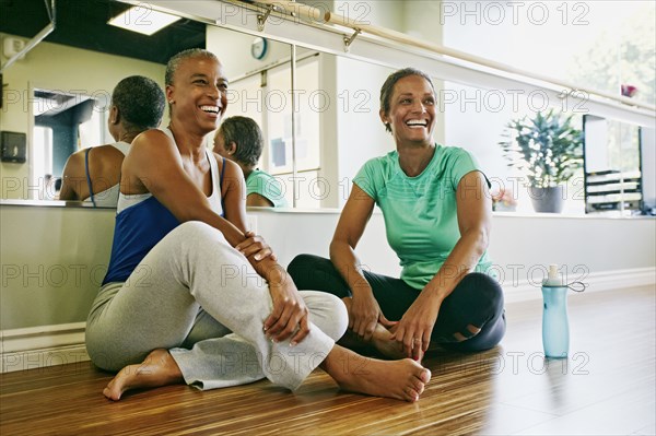 Women relaxing together in yoga studio