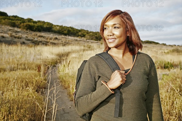 Black woman hiking on rural path