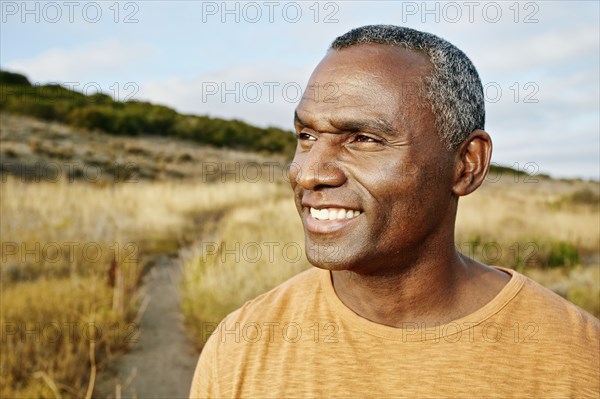 Black man standing on rural path