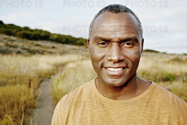 Black man standing on rural path